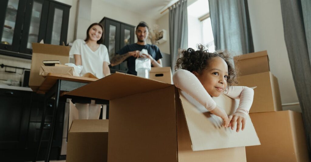 Family enjoys a joyful moment while unpacking boxes in their new kitchen.